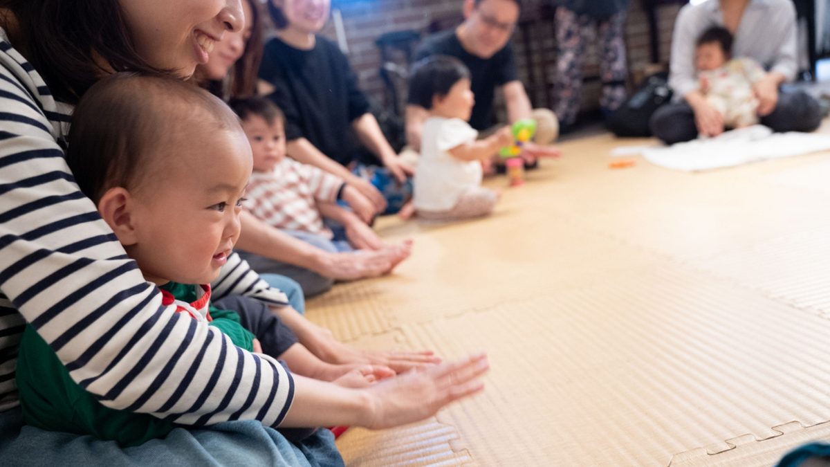 Families and travelers singing together at a World Song Circle in Kyoto